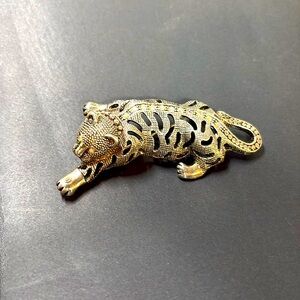 Silver tone leopard with amazing aurora borealis stone work on back and eyes.